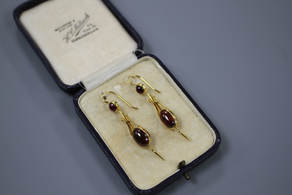 A pair of Victorian style yellow metal and cabochon garnet set drop earrings, overall 50mm, gross weight 5.1 grams.